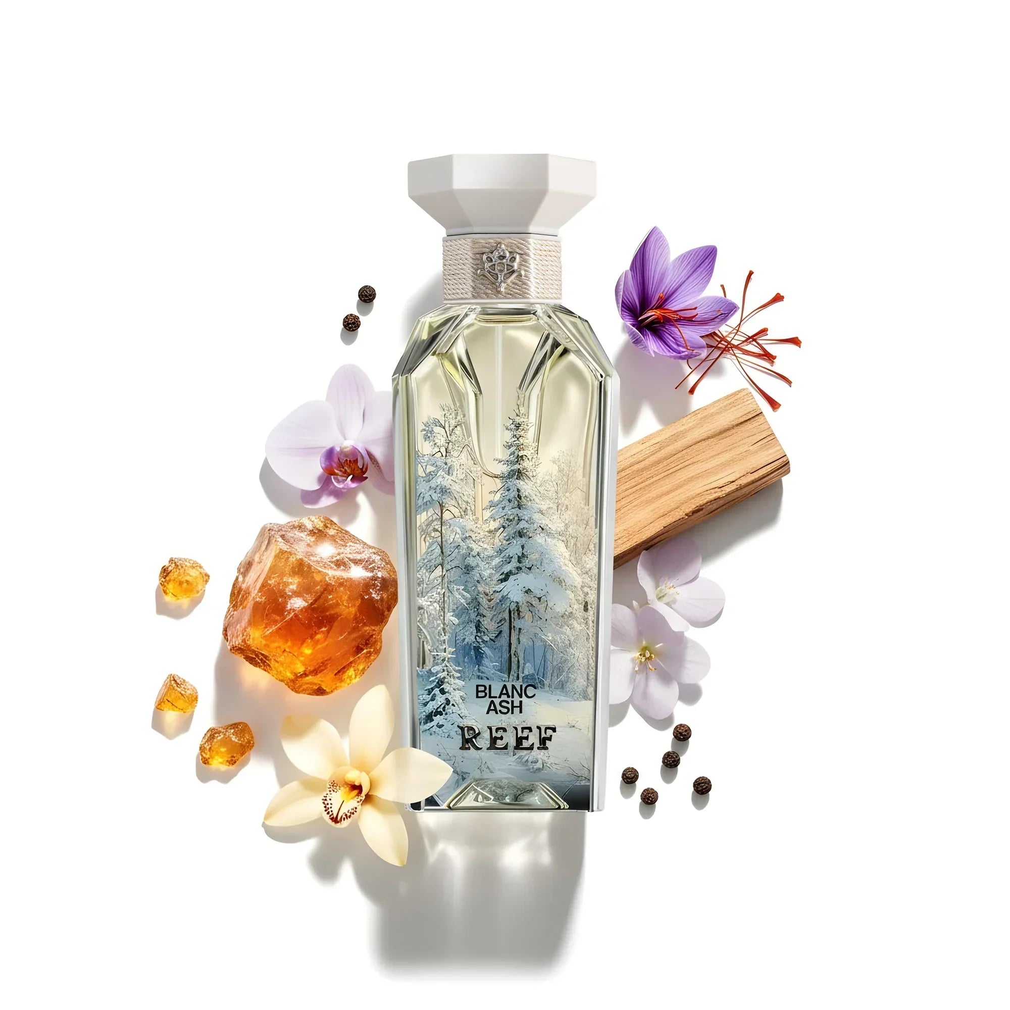 Blanc Ash REEF perfume bottle with snowy forest design, surrounded by orchids, amber, saffron, and wood