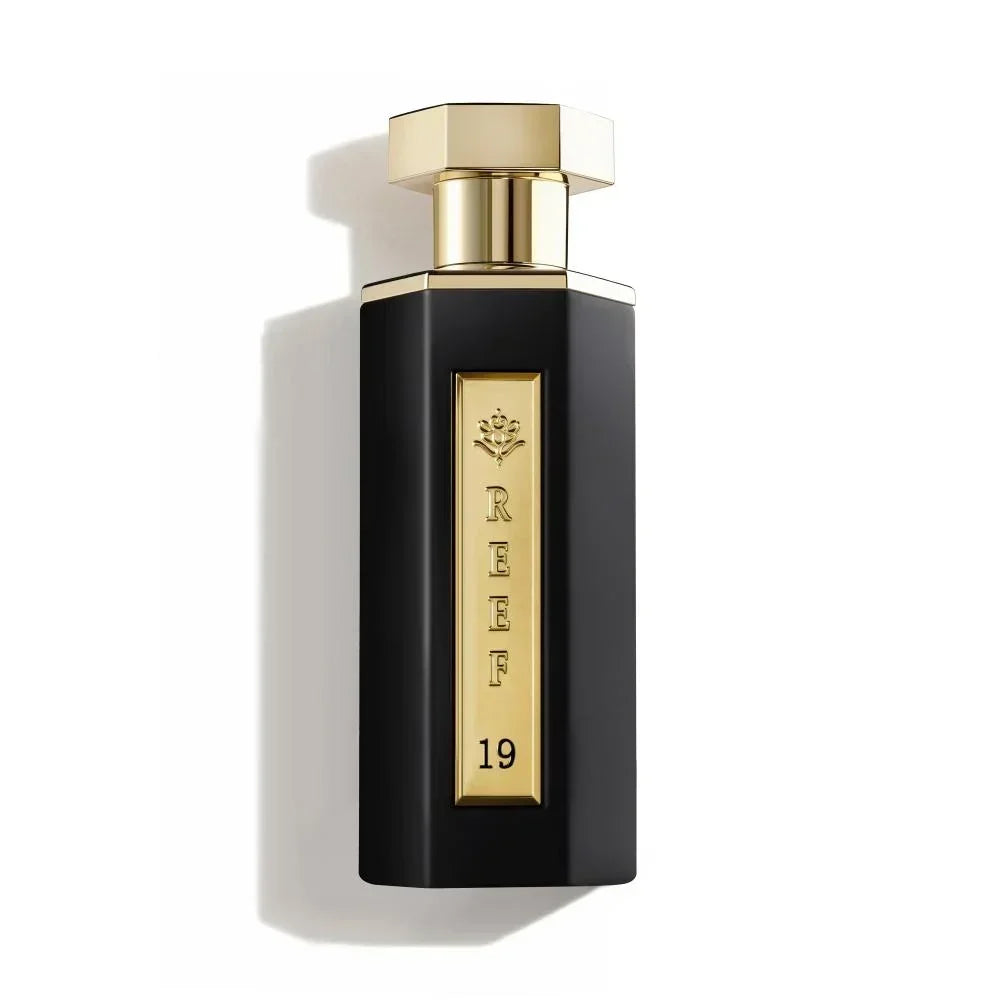 Elegant black perfume bottle with gold accents, labeled REEF 19, evoking luxury and oriental fragrance notes