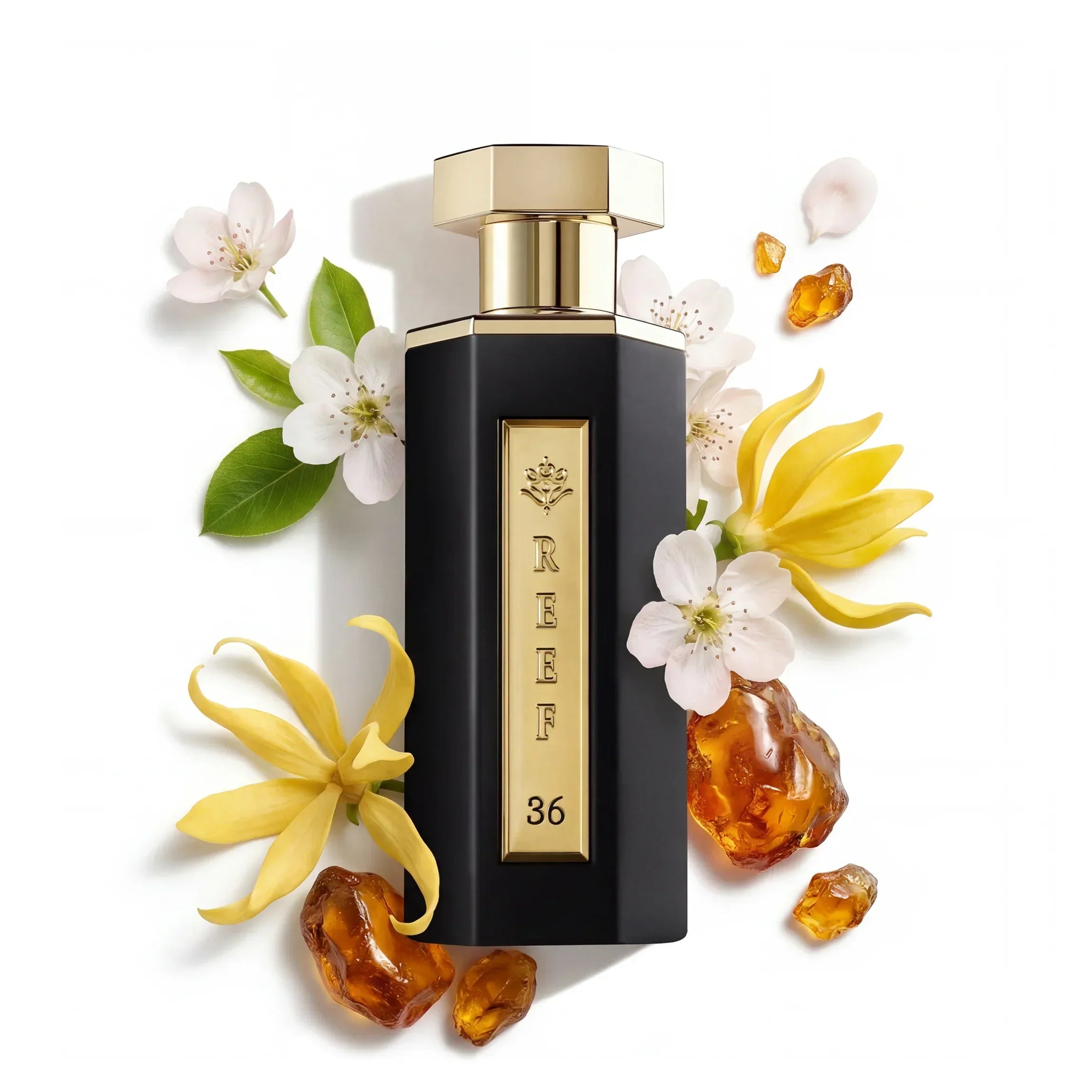 Luxury black perfume bottle with gold accents, surrounded by white blossoms, yellow flowers, and amber resin.